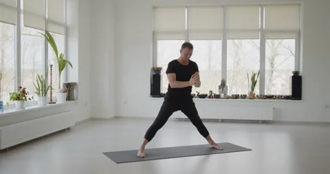 Professional trainer practices flow yoga in private class Stock Footage 156766772