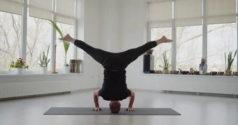 Professional trainer practices flow yoga in private class Stock Footage 156766830