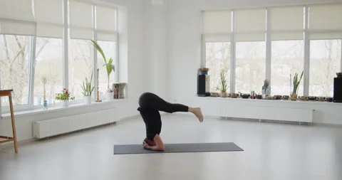 Professional trainer practices flow yoga in private class Stock Footage 156768096