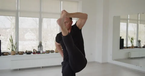 Professional trainer practices flow yoga in private class Stock Footage 156768431