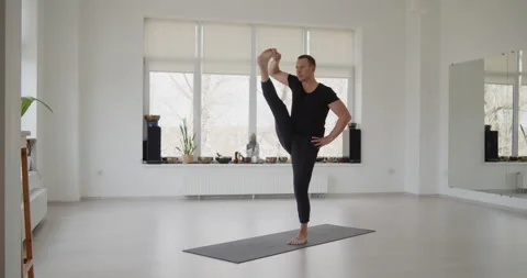 Professional trainer practices flow yoga in private class Stock Footage 156768523