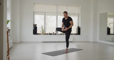 Professional trainer practices flow yoga in private class Stock Footage 156768626