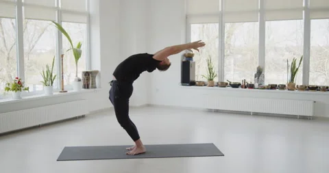 Professional trainer practices flow yoga in private class Stock Footage 156768820