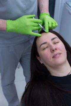 A Professional Treatment Session with a Skilled Practitioner Performing Facial Stock Photos