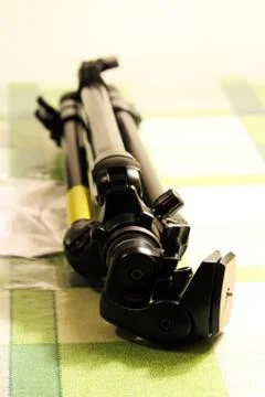 Professional tripod for the camera is on the table. Stock Photos