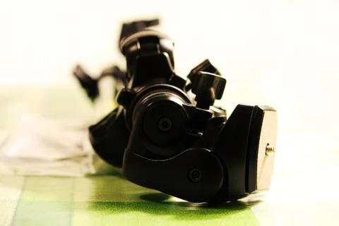 Professional tripod for the camera is on the table. Stock Photos