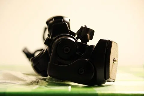 Professional tripod for the camera is on the table. Stock Photos