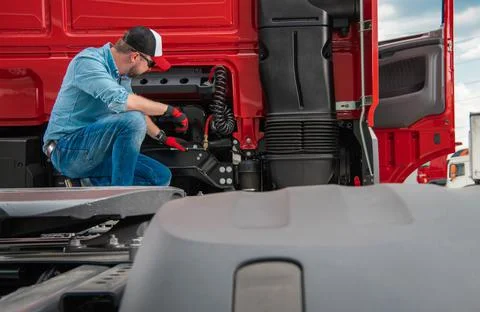 Professional Truck Driver Checking Systems in His Semi Truck Stock Photos