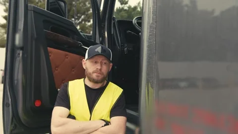 Professional truck driver posing next to his semi-truck Stock-Footage 346971783