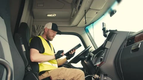 Professional truck driver using digital tablet in cabin Stock-Footage 346971270