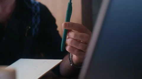 Professional Twirls Pen While Reviewing Work Materials Stock-Footage 313344593
