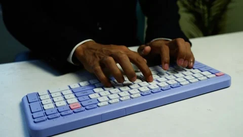 Professional typing on lavender computer keyboard, Close-up of a profession.. Stock Footage 348344992