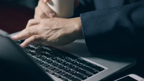 Professional user worker while drink a hot coffee and using typing on lapto.. Stock Footage 322555394
