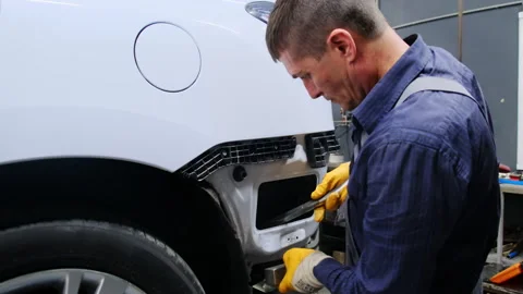Professional uses hammer to smooth surface of car rear Stock-Footage 317638099