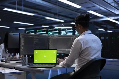 Professional using chroma key notebook to do checkup on server room rigs Foto stock