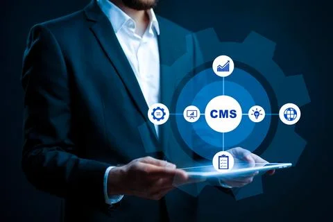 Professional using CMS on tablet with digital icons in dark setting Stock Photos
