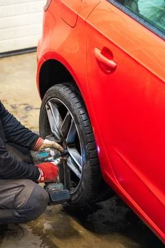 Professional Using an Impact Wrench for Winter Wheel Installation Stock Photos