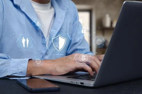 Professional using laptop with network security icons overlay Foto stock
