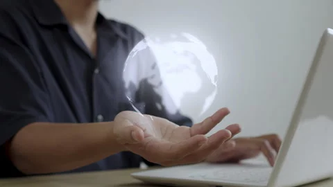 Professional using laptop technology with rotating interactive world hologram Vídeo Stock 345091878