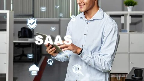 Professional using tablet in office while engaging with Software as a Servi.. Stock Photos