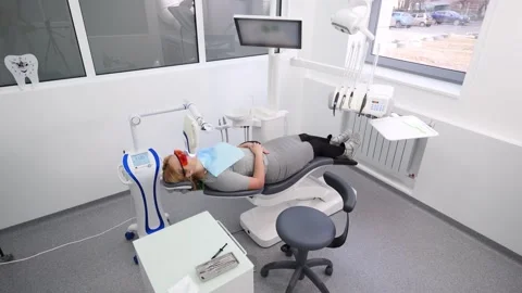 Professional UV teeth whitening procedure in modern dental clinic. Female Stock Footage 269489783