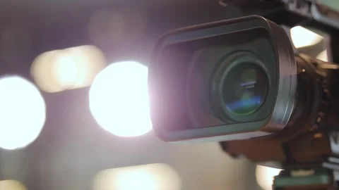 Professional video camera. Camera lens, bokeh background Stock Footage 246911623