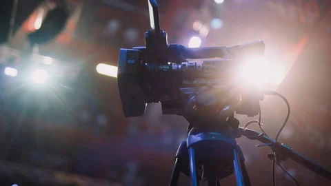 A professional video camera stands on a tripod before the start of the big event Stock Footage 124121837