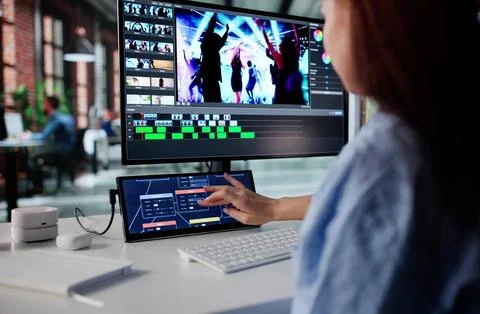 Professional Video Editor Enhancing Motion Graphics On Secondary Computer Pan Stock Photos