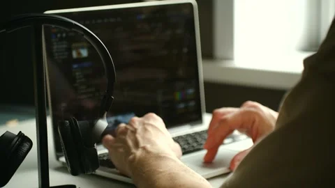 Professional video editor working on a laptop computer Stock Footage 337828490