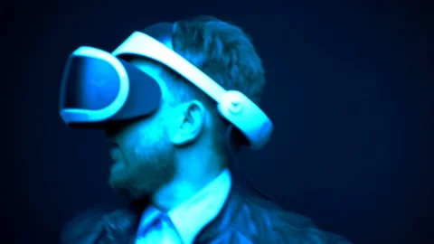 Professional video gamer testing virtual reality glasses, man dancing with Stock-Footage 121974909