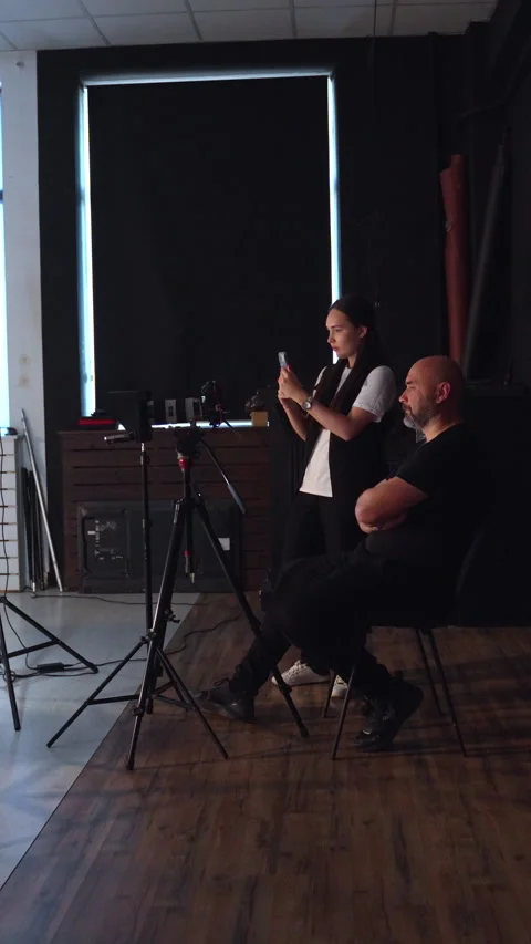 Professional video production crew working on set in dark studio. Vertical Stock-Footage 333148118