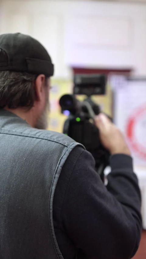 Professional Videographer Filming with Camera Stock Footage 325044820