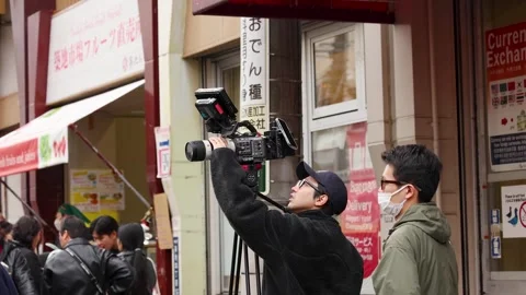 Professional Videographer Filming with Cinema Camera at Tsukiji Market Stock Footage 342468920