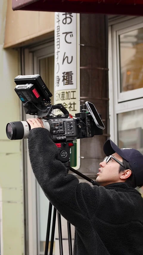 Professional Videographer Filming with Cinema Camera at Tsukiji Market Stock Footage 343610791