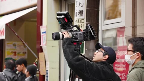 Professional Videographer Operating Cinema Camera on Tripod Stock Footage 341733421