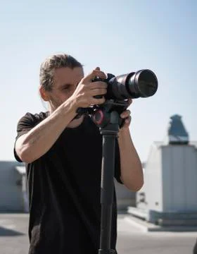 Professional videographer using cinema digital video camera. Stock Photos