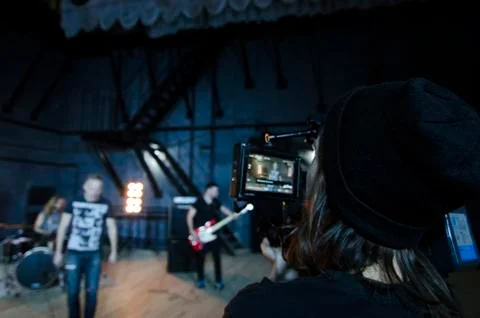 Professional videographer using cinema digital video camera for filming a music Stock Photos