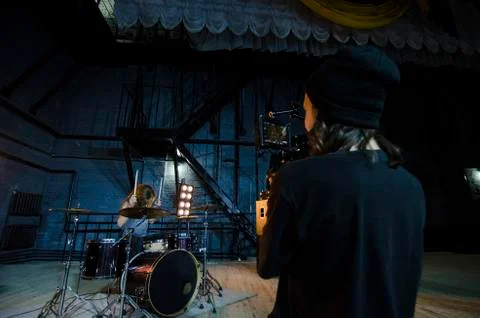 Professional videographer using cinema digital video camera for filming a Stock Photos