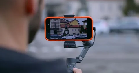 Professional Videographer Is Using The DJI Osmo Mobile 8 Handheld Device Video stock 328574807