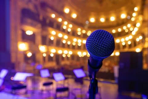 Professional Vocal Microphone on Stage with Blurred Opera House Background Stock Photos