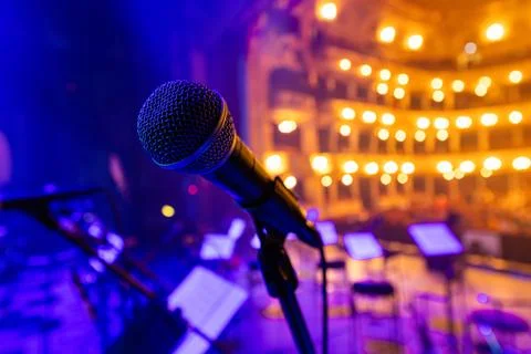 Professional Vocal Microphone on Stage with Blurred Opera House Background Stock Photos