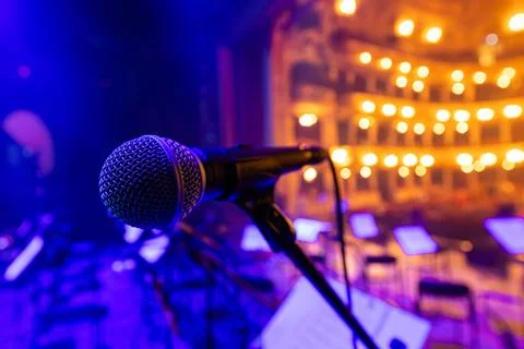 Professional Vocal Microphone on Stage with Blurred Opera House Background Stock Photos