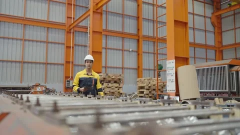 Professional warehouse manager using tablet for work walking and checking stock Stock Footage 239049384