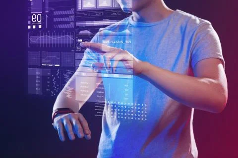 Professional web developer wearing a smart watch and making a hologram Foto stock