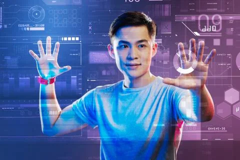 Professional web developer working with holographic images and looking impressed 库存照片