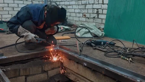Professional welder fabricating a metal structure with electric arc welding Stock Footage 335289117