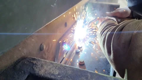 Professional welder in a garage. Worker welding steel structure close up Stock Footage 169087986