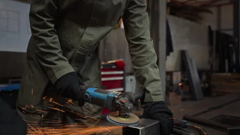 Professional Welder Grinding Metal with Angle Grinder in Workshop Stock Footage 342500857