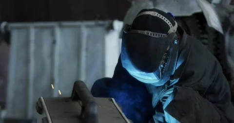 A professional welder makes steel structures at the factory. Stock Footage 166026246