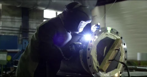 A professional welder makes steel structures at the factory. Stock Footage 166026971